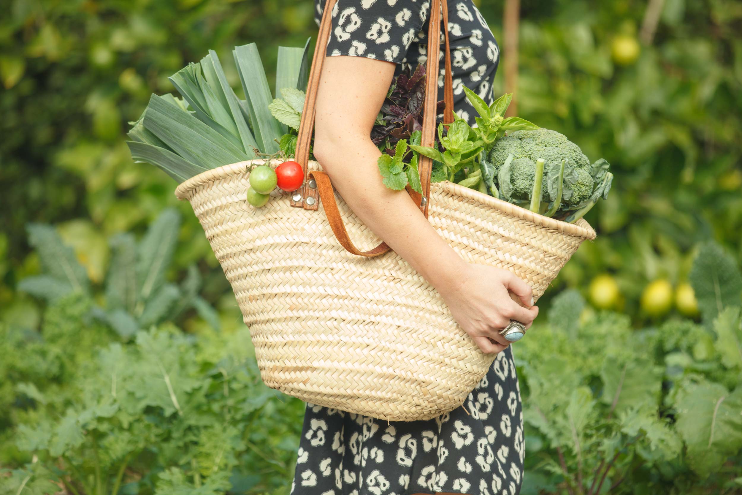 Lauren holding a bag full of organic home-grown produce.