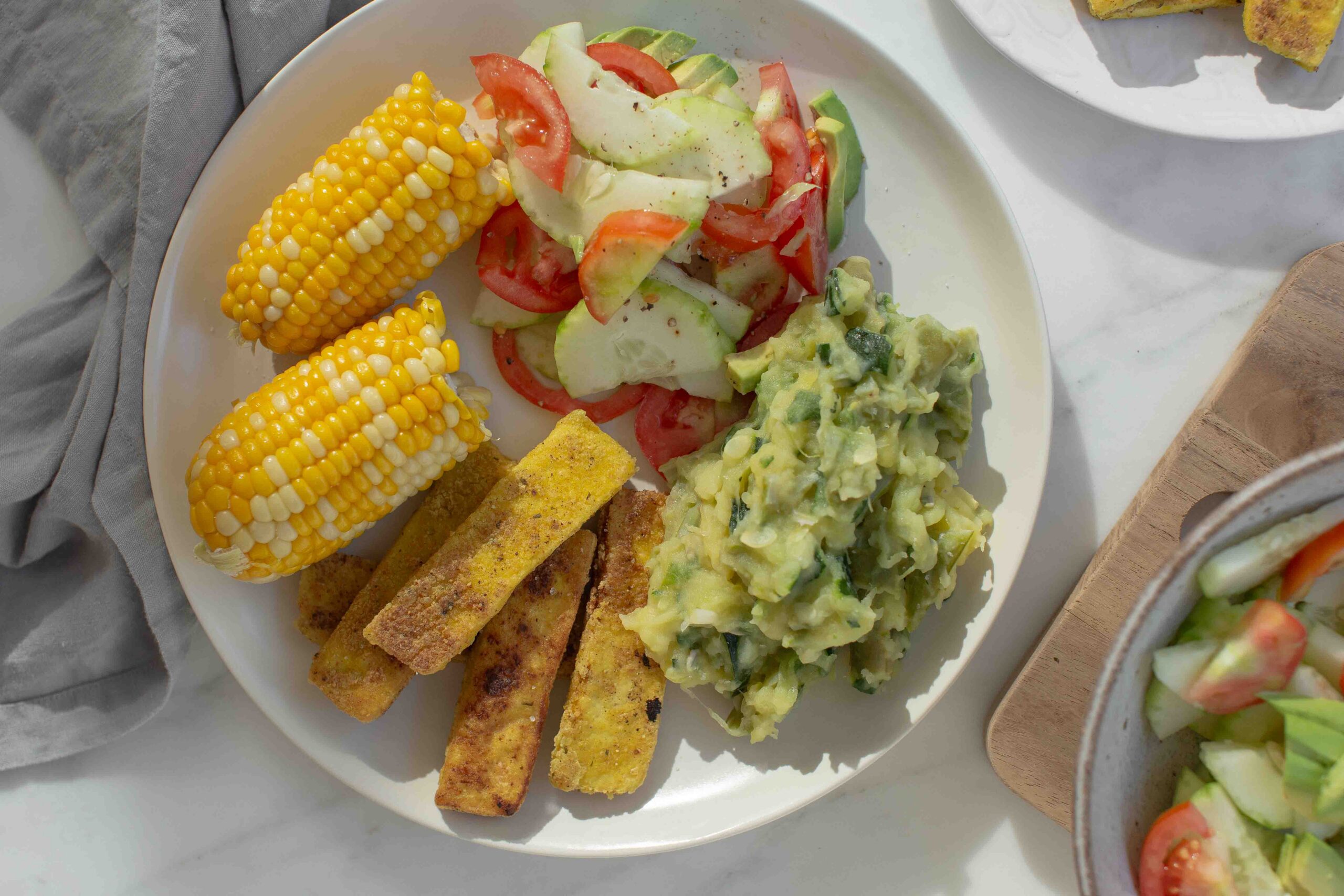 Dinner plate containing a few cobs of corn for the home sweetcorn test.