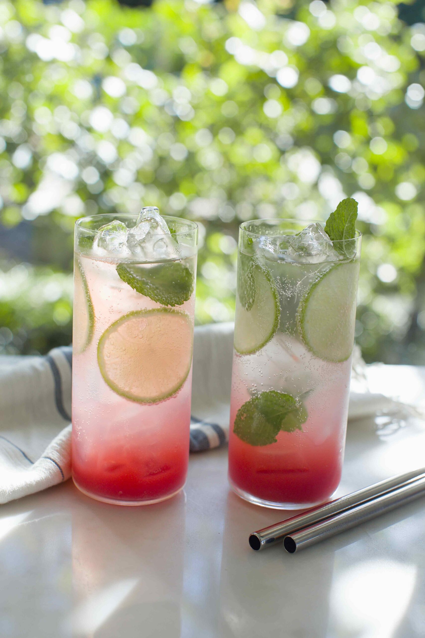 Two ombre magnesium mocktails on a kitchen counter.
